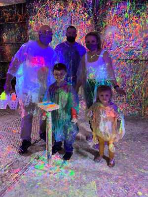 aunts and uncles have fun throwing paint with their nephew and niece
